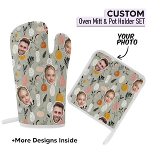 May include: Custom oven mitt and pot holder set with a light green background and a pattern of fruits, vegetables, and faces. The text "CUSTOM Oven Mitt & Pot Holder SET" is at the top. The text "YOUR PHOTO" is next to the pot holder.