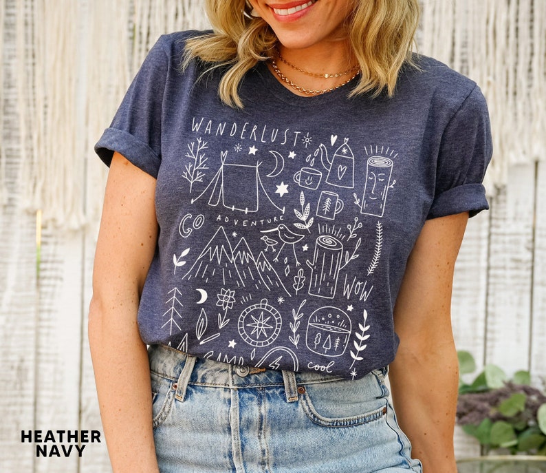 Illustrated adventure t-shirt featuring mountain and camping design, perfect for hikers, nature lovers, and outdoor vacations.