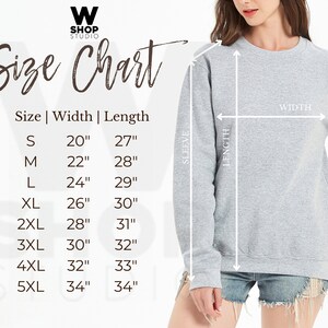 May include: Size chart for a sweatshirt with measurements in inches for width and length. The chart shows sizes from S to 5XL. The sweatshirt is gray and is being worn by a person.