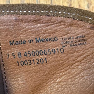 May include: Close-up of the inside of a brown leather boot. The text "Made in Mexico" is visible, along with "7.5 B 4500065910 10031201". The boot has a rubber outsole and leather uppers.