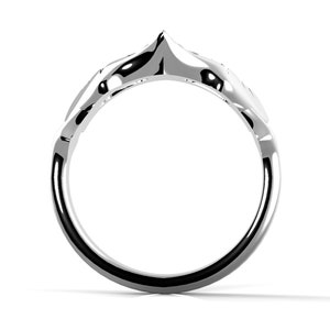 May include: A silver ring with a distinctive, pointed design. The ring is crafted from smooth metal and has a simple, elegant style.