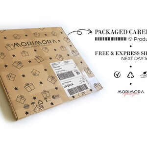 May include: A brown cardboard box with a white label and barcode. The box is decorated with a pattern of stars and gift boxes. The text "MORIMORA" is printed on the box. The text "PACKAGED CAREFULLY" and "FREE & EXPRESS SHIPPING" is printed on a white background.