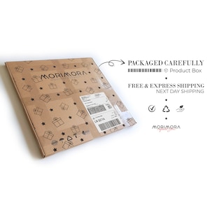 May include: A brown cardboard box with a white label and the text "MORIMORA" and "www.morimora.com". The box is decorated with a pattern of stars and gift boxes. The text "PACKAGED CAREFULLY" and "FREE & EXPRESS SHIPPING NEXT DAY SHIPPING" is printed on a white label on the right side of the image.