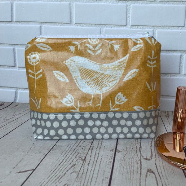 Mustard Yellow Scandi Style Bird Oilcloth Makeup Bag with a wipe clean lining. Handmade Bird Beauty Bag ideal for travelling and storage.