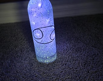 Botella luminosa del zodíaco con luces