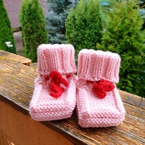 Merino wool knitted pink booties for infant baby girl.