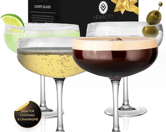 May include: Four clear coupe glasses, each with a long stem and a wide, shallow bowl. One glass contains a green cocktail with a lime wedge, another has champagne, and a third holds a dark brown drink. A box with the text "COUPE GLASS" is in the background.