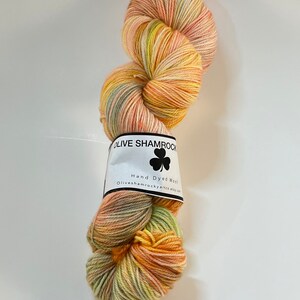 Party Peach is a hand dyed fingering weight superwash wool. It is 414 yards and is 75% merino and 25 percent nylon, perfect for socks.