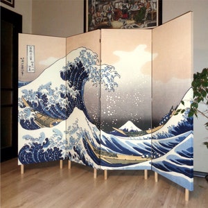 May include: A four-panel room divider screen with a Japanese wave design. The screen is made of wood and fabric and features a depiction of the Great Wave off Kanagawa by Katsushika Hokusai. The screen is beige with a blue and white wave design.