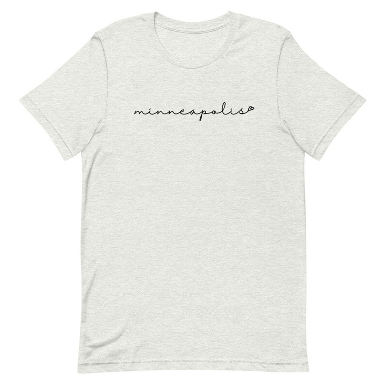 May include: A heather grey t-shirt with the word "minneapolis" written in black cursive script.