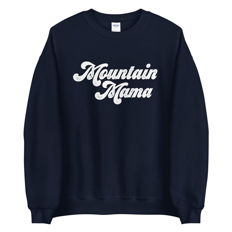 May include: A navy blue sweatshirt with the text "Mountain Mama" in white retro-style lettering.