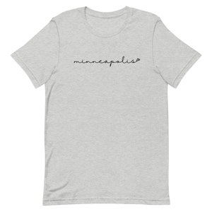May include: A heather gray t-shirt with the word "minneapolis" written in black cursive script.