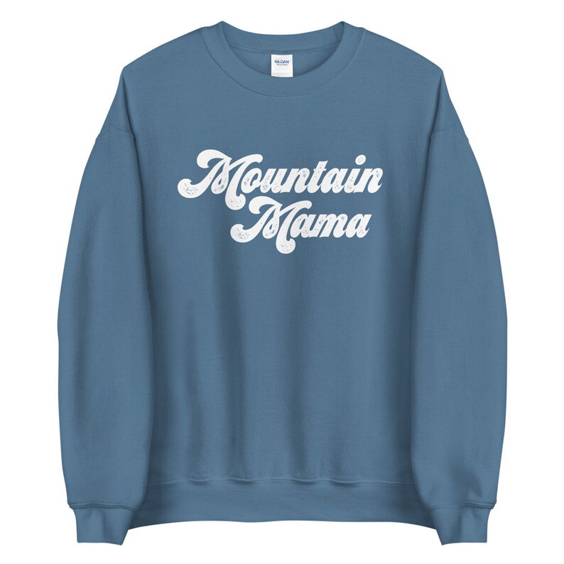 May include: A blue sweatshirt with the text "Mountain Mama" in a white retro font.
