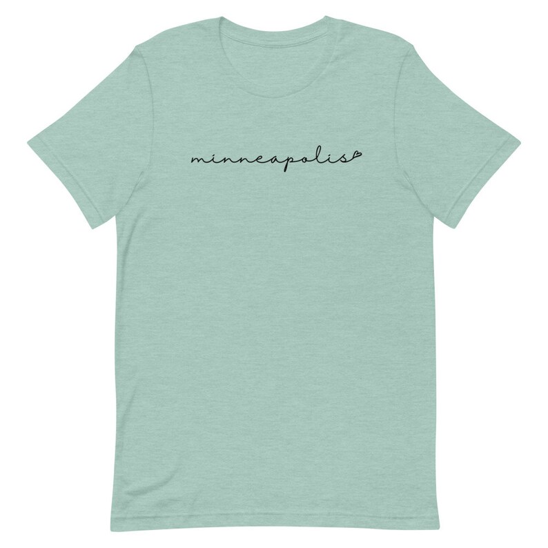 May include: A light blue t-shirt with the word "minneapolis" written in black cursive script.