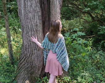 Luxury hand-knit wrap in green with hints of blue and pink