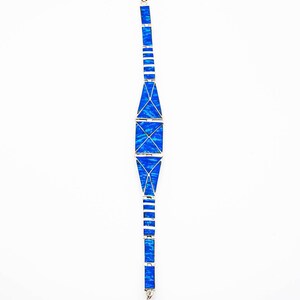 May include: A silver bracelet with a geometric design featuring blue opal stones.