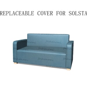 May include: A blue fabric sofa with replaceable covers. The sofa has a simple design with a rectangular shape and a low back.