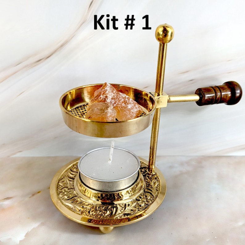 May include: Brass incense burner kit with a wooden handle, a small candle holder, and a piece of orange selenite. The kit is labelled "Kit #1".