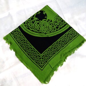 May include: Green and black tapestry with a Celtic knot design. The design features a tree of life motif in the center.