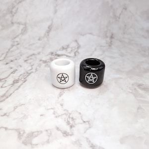 Two ceramic spell candle holders with pentacle symbols, tools used in witchcraft