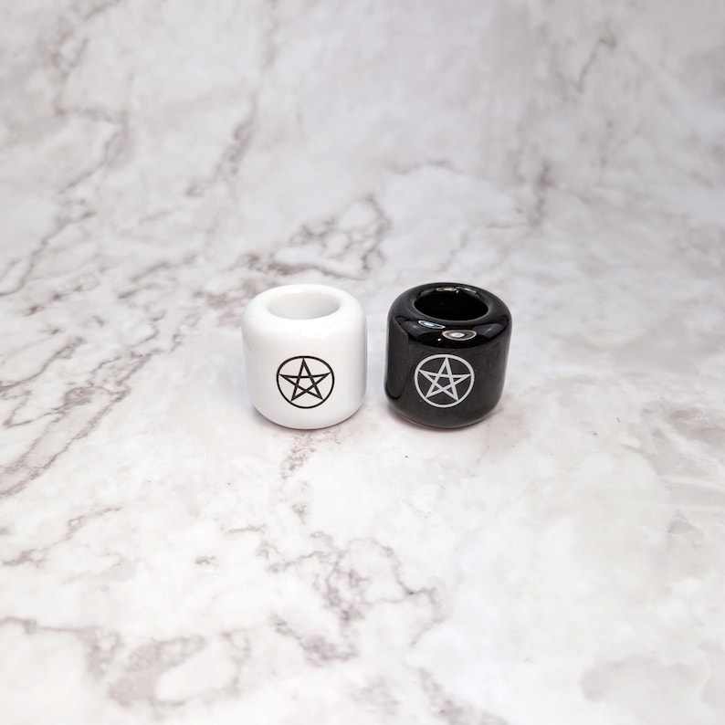 Two ceramic spell candle holders with pentacle symbols, tools used in witchcraft