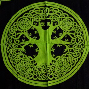 May include: A green Celtic tree of life design on a black background. The tree is surrounded by a circle of intricate knots.