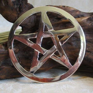 May include: A silver-colored metal pentagram pendant with a five-pointed star design. The pendant is round and has a smooth, polished finish.