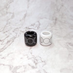 Two ceramic ritual candle holders with triple moon symbols