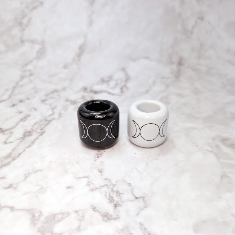 Two ceramic ritual candle holders with triple moon symbols