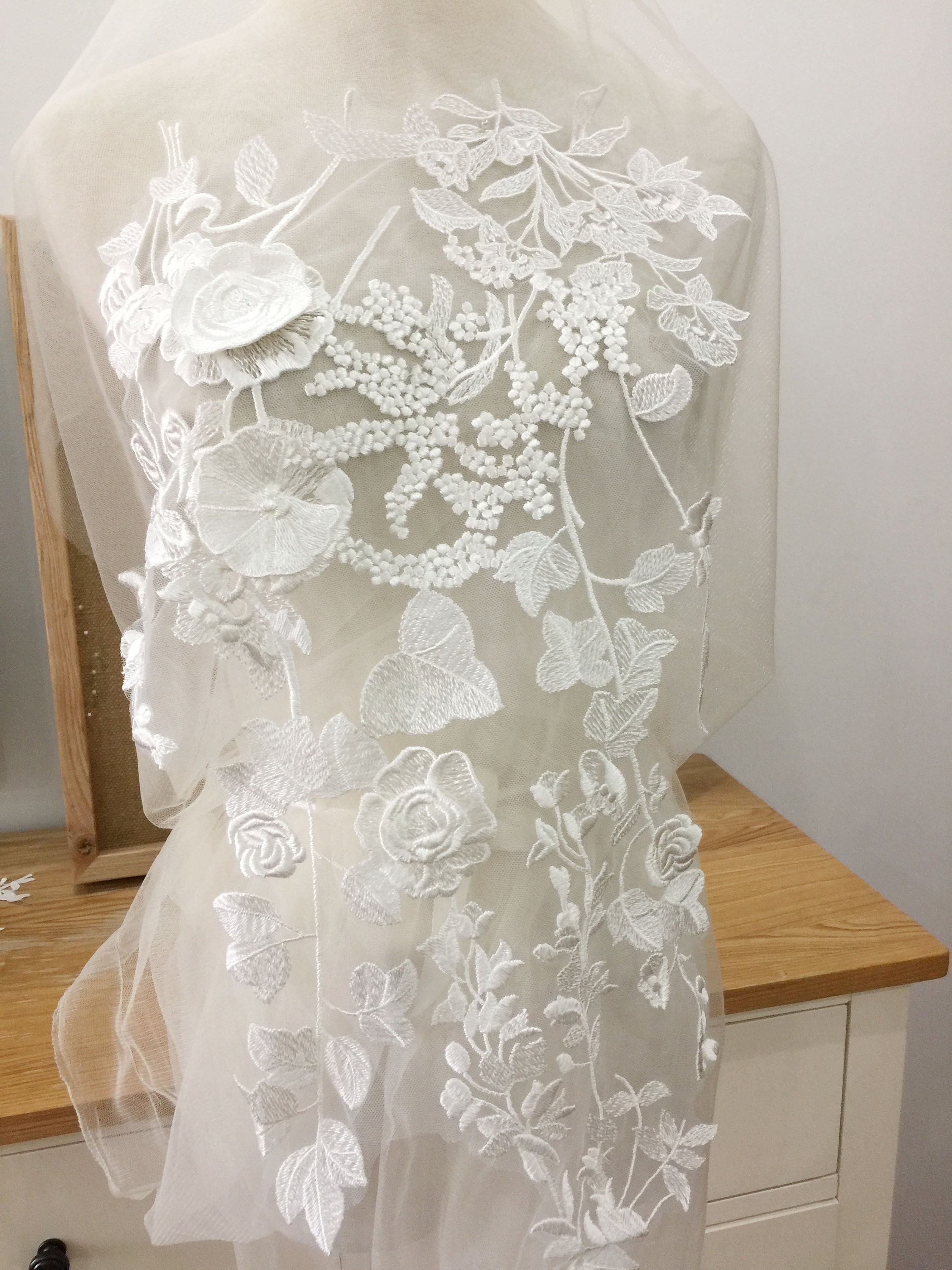 Floral lace appliqué over layered tulle