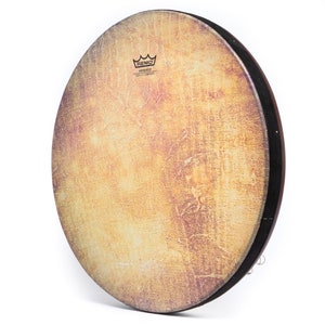 May include: A brown Remo Skindeep 20-inch frame drum with a natural coloured drumhead. The drumhead has a distressed, aged look with a subtle purple hue. The Remo logo is printed on the drumhead.