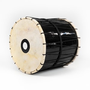 May include: A black drum with a white drumhead and a black center hole. The drum is wrapped with black rope and has a glossy finish. The drum's edges are a light beige color.