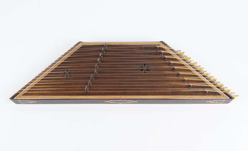 May include: A wooden santur, a hammered dulcimer, with a dark brown finish and gold tuning pegs. The instrument has a decorative inlay around the edge.