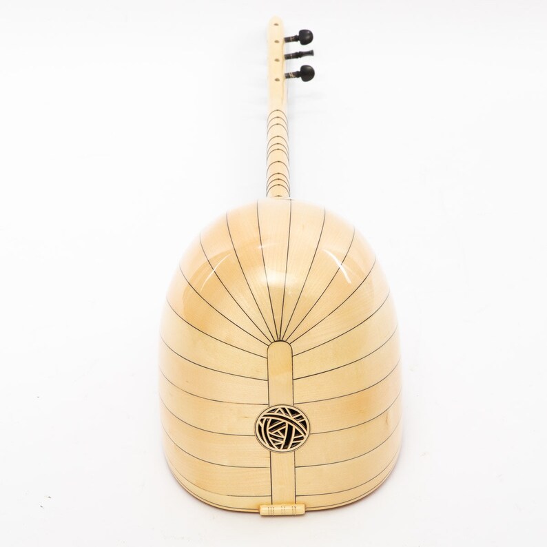 May include: A light wood  saz, a Turkish stringed instrument, with a round body and a long neck. The body is decorated with black lines and a circular sound hole.