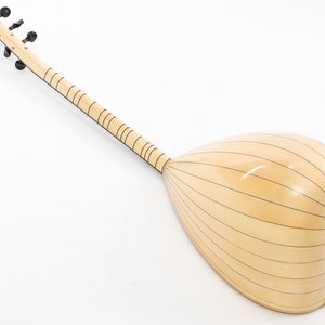 May include: A light wood  saz, a Turkish stringed instrument, with a pear-shaped body and a long neck with tuning pegs. The body is decorated with thin black lines.