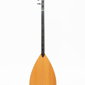 May include: A traditional Turkish stringed instrument called a Saz. The Saz has a pear-shaped body, a long neck with tuning pegs, and a wooden soundboard.