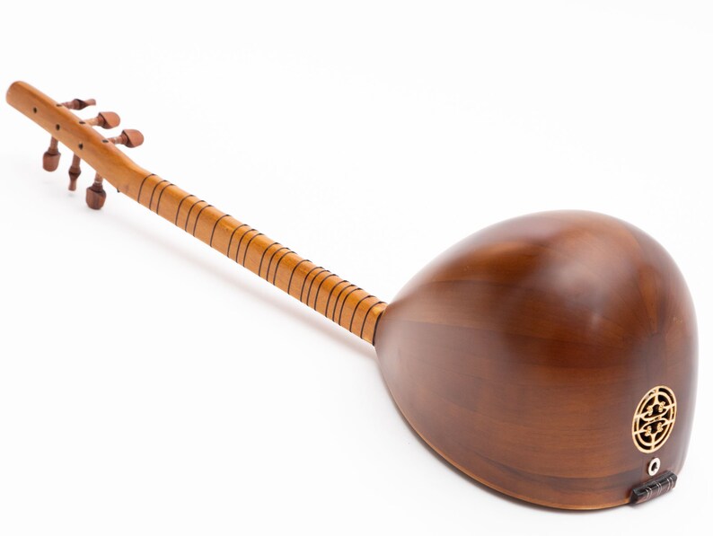 May include: A wooden stringed instrument with a long neck and a rounded body. The instrument is a warm brown color, with a lighter-colored neck and tuning pegs. The body features a decorative gold-colored sound hole.