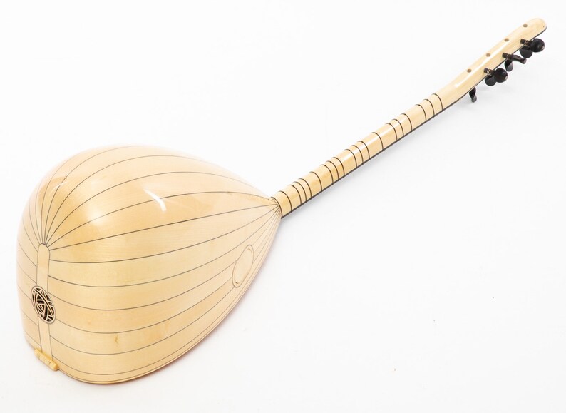 May include: A light wood  saz, a Turkish stringed instrument, with a pear-shaped body and a long neck. The instrument has a natural wood finish and black tuning pegs.