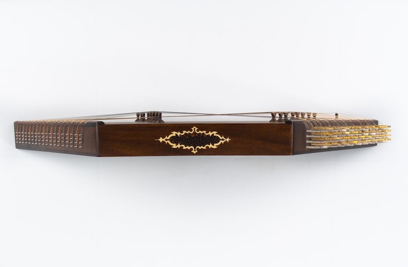 May include: A dark brown wooden dulcimer with gold-coloured tuning pegs and a decorative inlay on the front.