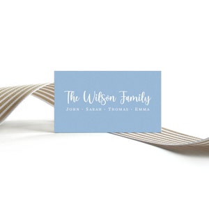 May include: A light blue card with white text that reads "The Wilson Family" and "JOHN - SARAH - THOMAS - EMMA".