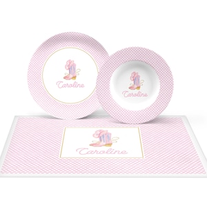 May include: Pink and white gingham place setting with a pink cowboy boot design and the name "Caroline" on each piece.