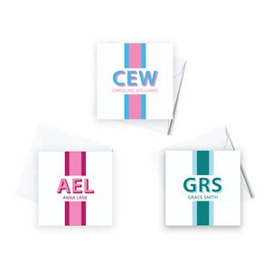 May include: Three personalized note cards with a single stripe down the center. The top card is blue and pink with the initials "CEW" and the name "CAROLINE WILLIAMS". The middle card is pink with the initials "AEL" and the name "ANNA LANE". The bottom card is teal with the initials "GRS" and the name "GRACE SMITH".