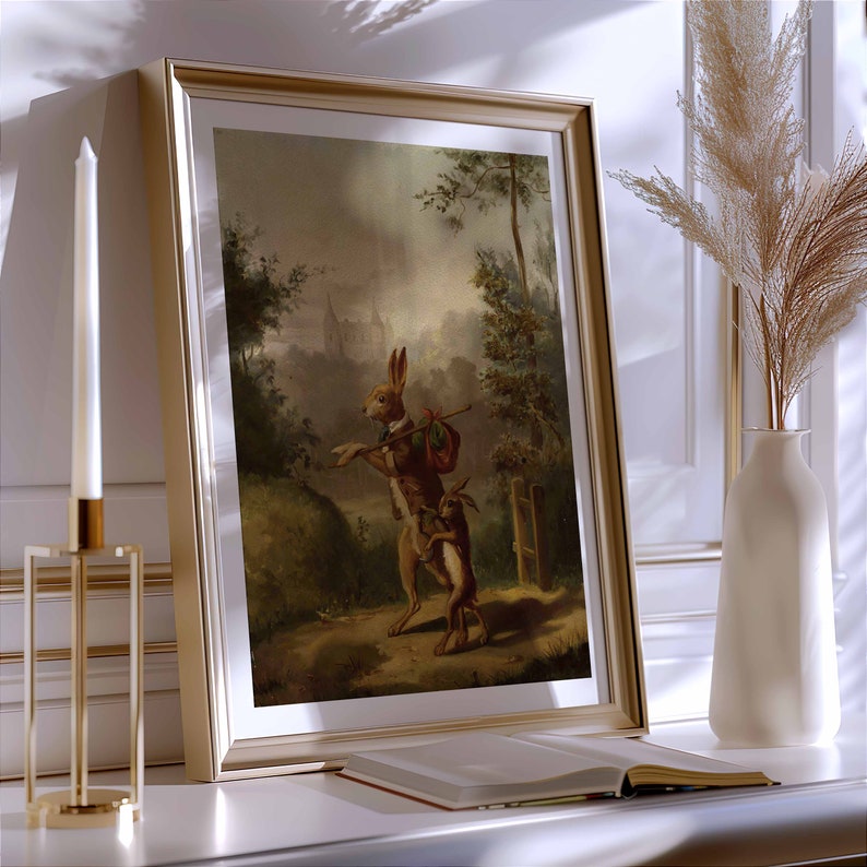 May include: A framed painting of two rabbits in a forest setting. The larger rabbit is holding a stick and a bag, while the smaller rabbit follows behind. The painting is set against a backdrop of trees and a distant building.