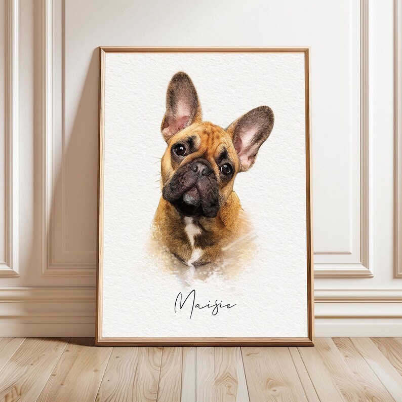 May include: A framed portrait print featuring a brown and tan French Bulldog with large ears and a black muzzle. The dog has a small white patch on its chest. Below the dog, the name Maisie is written in a thin, black, cursive script font.