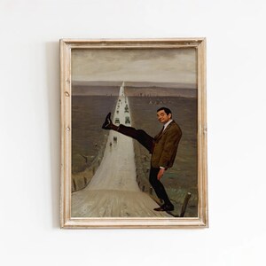 May include: A framed wall art print featuring a painting of a long, straight road stretching into the horizon. A man in a brown tweed blazer and dark trousers is superimposed in the foreground, standing on one leg with the other raised high.