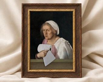 May include: A framed painting depicting an elderly person wearing a white head covering and a pink garment, holding a roll of white toilet paper. The artwork is encased in a dark brown wooden frame with a thin gold inner border.