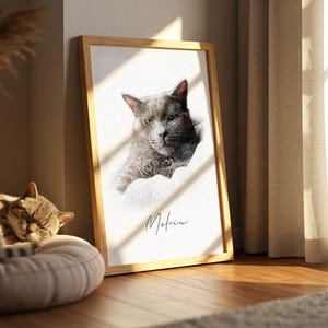 May include: A rectangular wooden frame containing a portrait of a grey cat with a dark collar. The portrait features a white background and the name Melvin written in black cursive script below the cat. The frame is positioned upright.