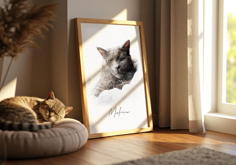 May include: A rectangular wooden frame containing a portrait of a grey cat with a dark collar. The portrait features a white background and the name Melvin written in black cursive script below the cat. The frame is positioned upright.