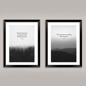 May include: Two black framed prints with inspirational quotes about nature. The left print features a black and white photo of a forest with the quote "Into the forest I go, to lose my mind and find my soul." The right print features a black and white photo of mountains with the quote "The mountains are calling and I must go."