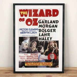 May include: A vintage movie poster for the film "The Wizard of Oz" featuring Judy Garland, Ray Bolger, Jack Haley, and Bert Lahr. The poster is in black and white with a red and yellow title and features a scene from the film with Dorothy, the Tin Man, the Scarecrow, and the Cowardly Lion.